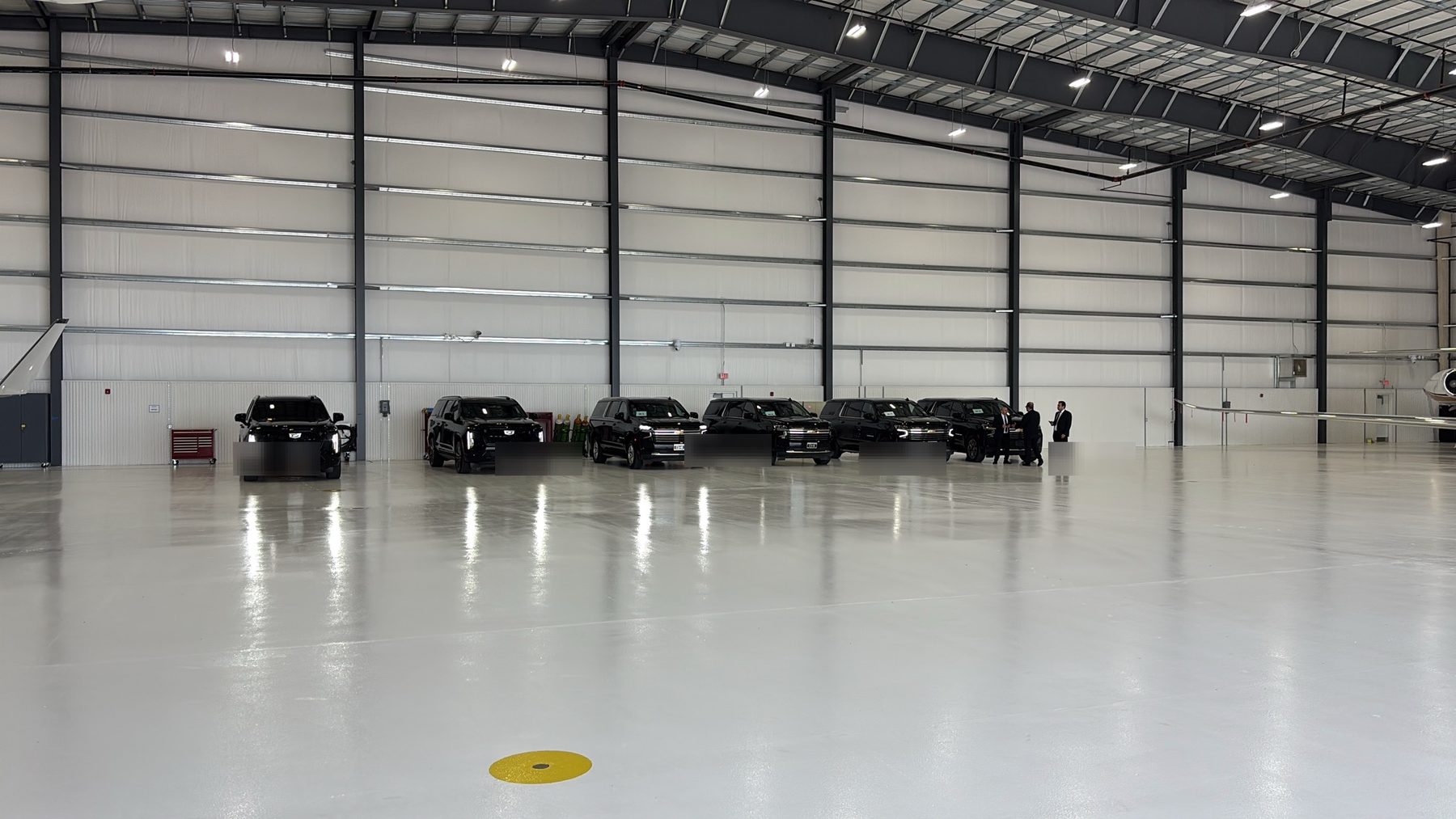 Protective vehicles staged inside a private aviation hangar