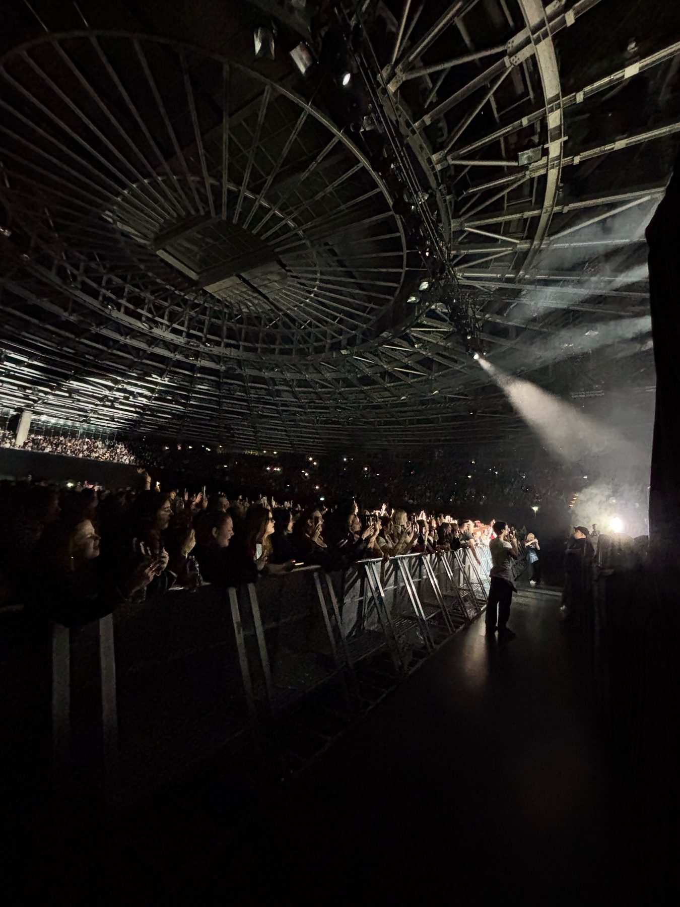 Crowd barricade corridor under concert lighting