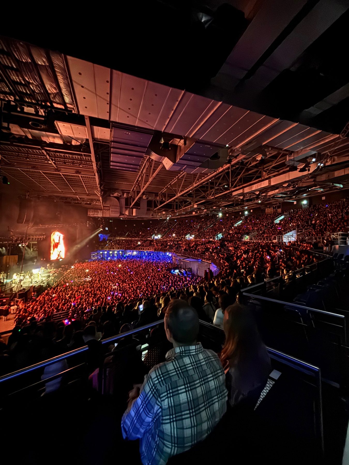 Large arena concert with pyrotechnics and full crowd