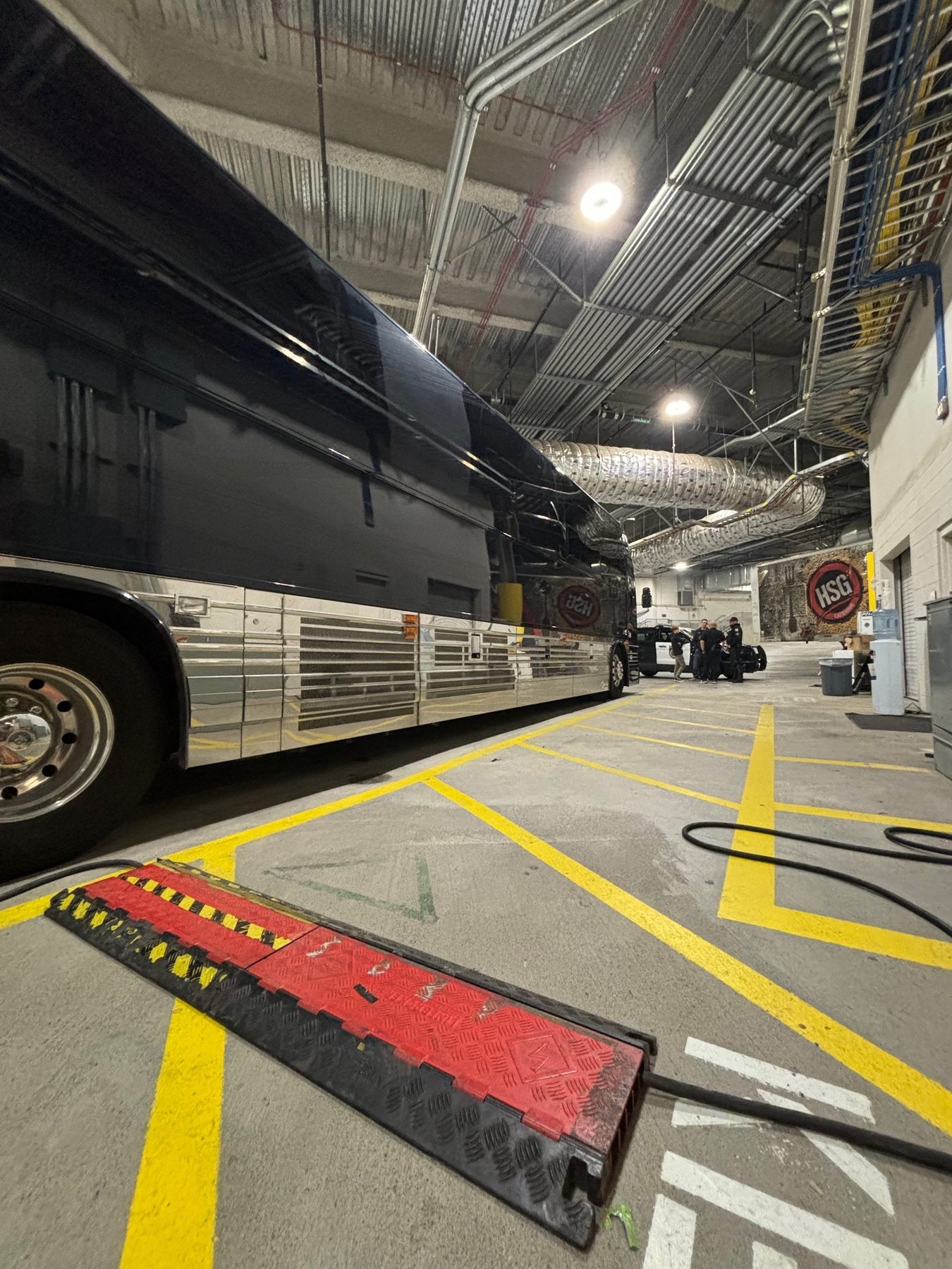 Tour bus positioned inside a venue loading area